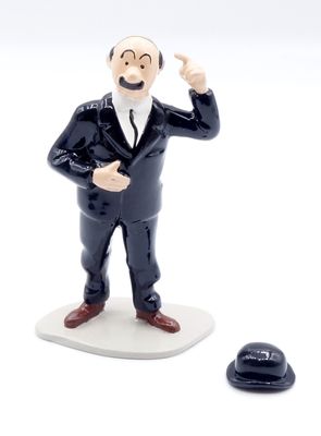 une figurine représentant un homme en smoking, à côté d'un chapeau