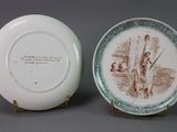 pair of porcelain plates with a scene of a man and a woman on them