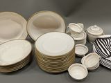 a lot of plates and bowls that are sitting on a table