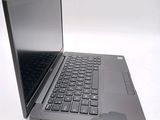 a laptop with a black keyboard sitting on a white surface