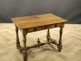 an old wooden table with a drawer on top of it