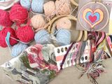 many balls of yarn on a table with a heart on it