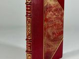 the book is red and gold with gold trimmings on it