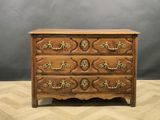 an antique chest of drawers with ornate carvings and brass handles