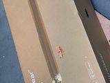 a cardboard box sitting on the ground next to a skateboard