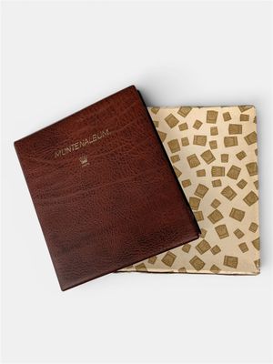 a brown book with a brown cover sitting on top of a white surface