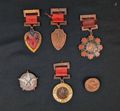 several medals and medals are displayed on a black surface
