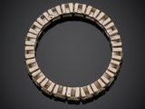 an image of a bracelet made out of metal strips on a black surface