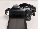 a camera and a tablet on a white surface