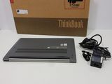 a laptop that is sitting on a table next to a box