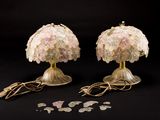 pair of pink and gold table lamps on a black background