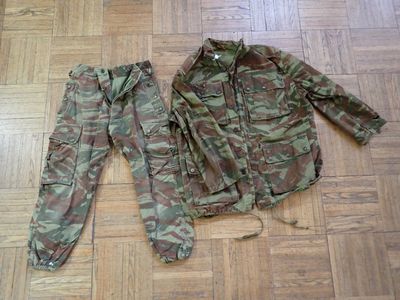 a camouflage jacket and pants sitting on the floor