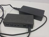 a black charger sitting on top of a table next to a charger