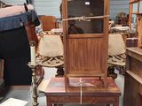 a wooden cabinet with a glass door on top of a table