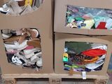 two cardboard boxes with items in them sitting on a pallet