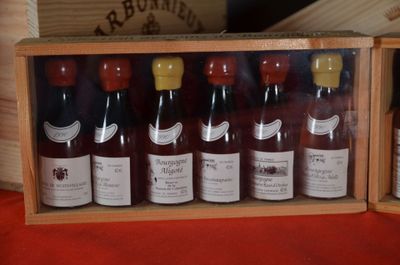 bottles of wine in a wooden box on a table