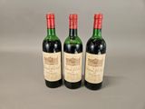 three bottles of wine sitting on top of a table next to each other