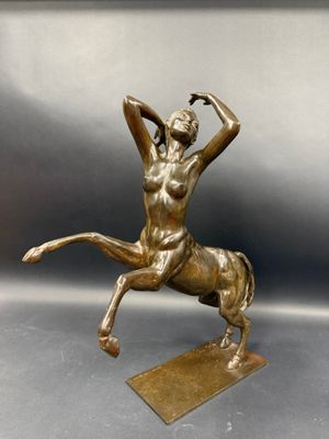 bronze statue of a woman on a horse on a base