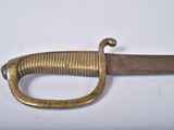 a close up of a sword on a white surface