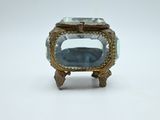 a small glass box with a blue stone inside of it