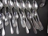 a lot of silver spoons and spoon spoons on a table