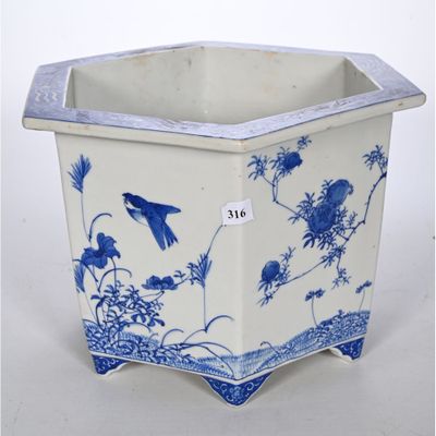 une jardinière bleue et blanche décorée d'oiseaux et de fleurs