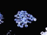 several pieces of blue and white crystals are scattered on a black surface