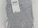 a close up of a pair of grey pants on a white surface
