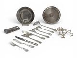 many different types of silverware on a white surface