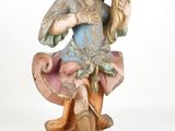 an old statue of a woman holding a fan on a white background