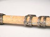 three rings on top of a stick on a white surface