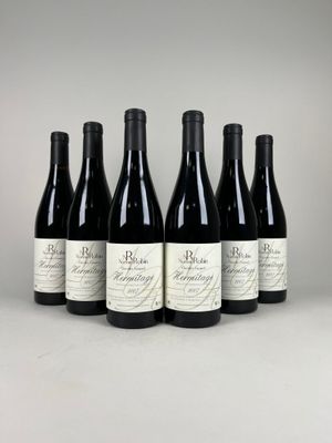 six bottles of red wine lined up in a row