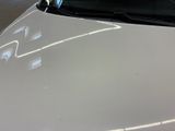 a close up of a white car in a garage