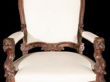 an old chair with a white upholstered seat and a wooden frame