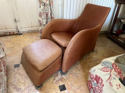 a brown chair and ottoman in a living room