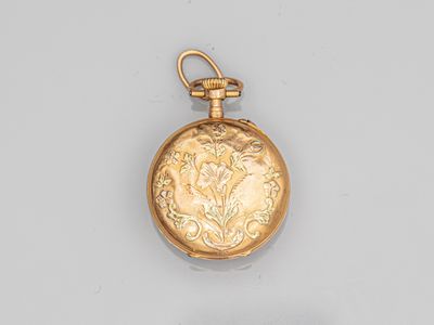 an antique gold pocket watch with a floral design on the face