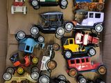 a cardboard box filled with various toy cars and trucks