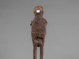 a wooden statue of a man with a helmet on his head