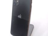 a black iphone sitting on a stand on a white surface