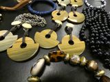a lot of necklaces and bracelets on a table
