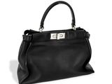 a black leather handbag with a metal handle on a white background