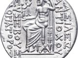 a silver coin with an image of a woman sitting on a chair