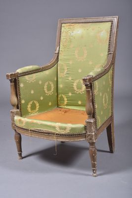 an old chair with a green upholstered back and gold trim