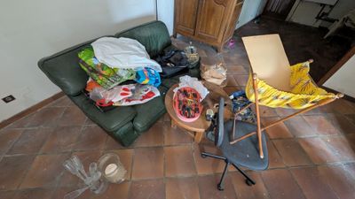 a living room with a green couch and a chair