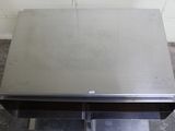 a stainless steel table with two drawers underneath it