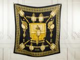 a black and gold scarf hanging on the wall
