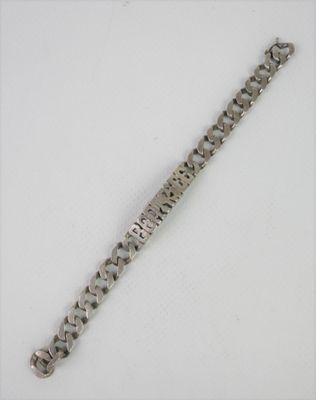 an image of a silver bracelet on a white surface