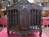 a wooden bed with a carved headboard and foot board