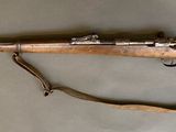 a rifle that is laying on a table with a strap