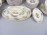a lot of plates and bowls on the table